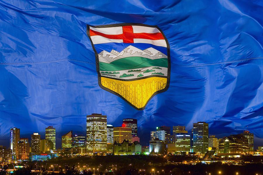 The Alberta flag flying over the Edmonton skyline
