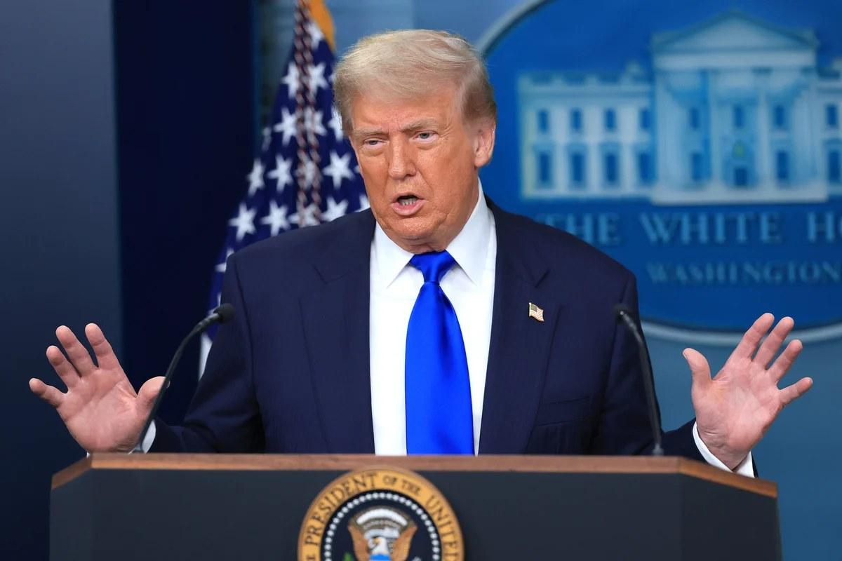 President Donald Trump speaking to reporters behind the presidential lectern at the White House