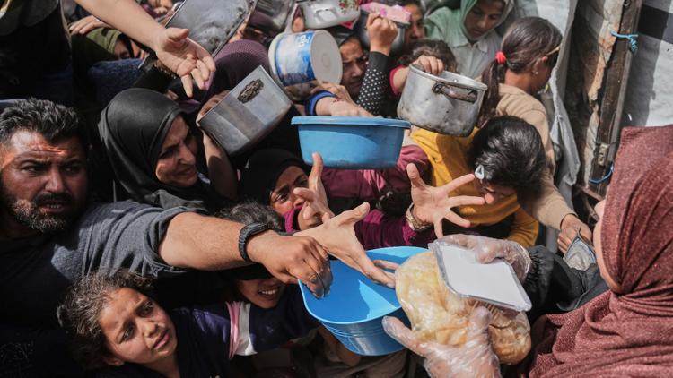 Palestinians gathering to receive humanitarian food aid in Gaza